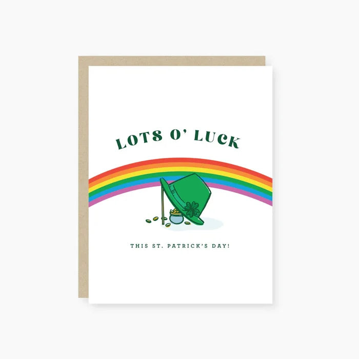 A greeting card with a cartoon illustration of a leprechaun, a pot of gold, and a rainbow, with 'Lots O'Luck' and 'This St. Patrick's Day!' text, accented with gold foil.