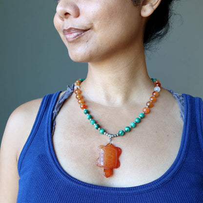 model wearing carnelian turtle malachite necklace
