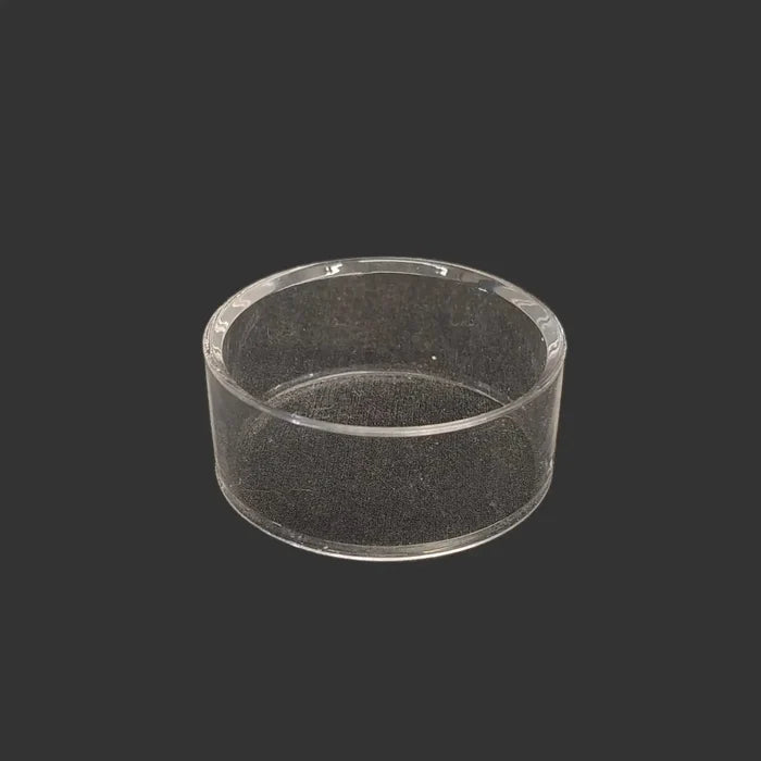This acrylic riser display stand is clear, glossy, and round in shape.