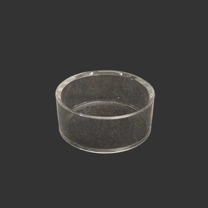 This acrylic riser display stand is clear, glossy, and round in shape.