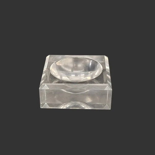 This acrylic stand is clear, glossy, and square in shape.