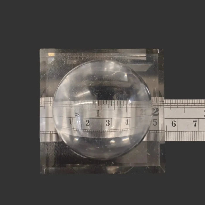 This square acrylic display stand is 2 inches in diameter.