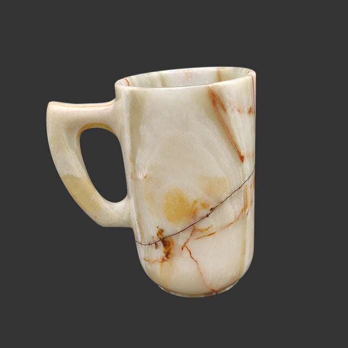 The right side of this onyx mug is mostly cream, a line of black, and brown and orange.