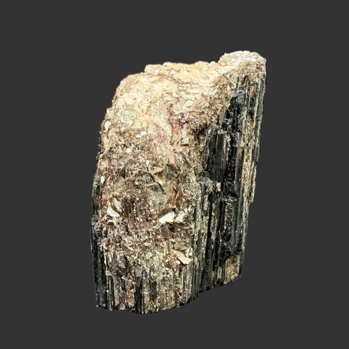 This is the front view of this piece of free-standing Tourmaline. It is lack, cream, and gold in color.