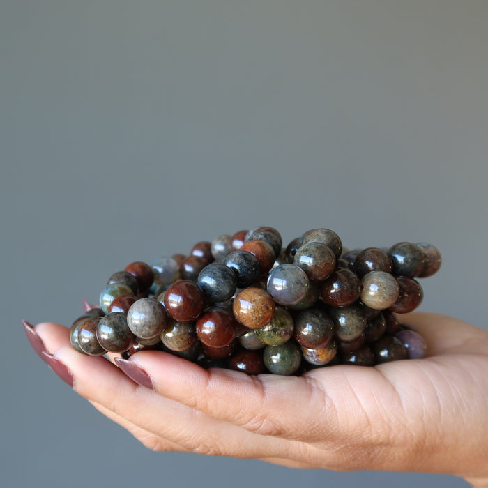 pile of multi colored moss agate bracelets