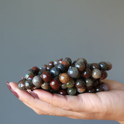 pile of multi colored moss agate bracelets