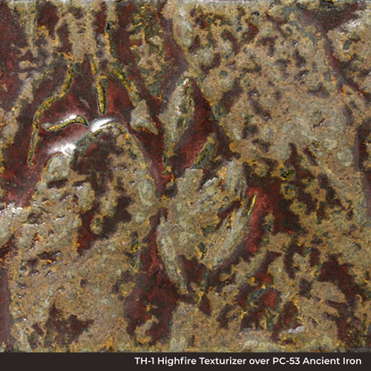 Close-up of TH-1 Highfire Texturizer over PC-53 Ancient Jasper glaze, mottled and pitted red, gold and olive surface