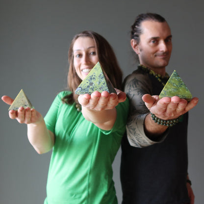 people holding serpentine pyramids